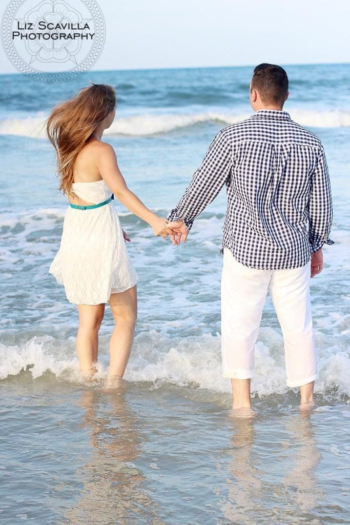 Couple Walking Along The Beach