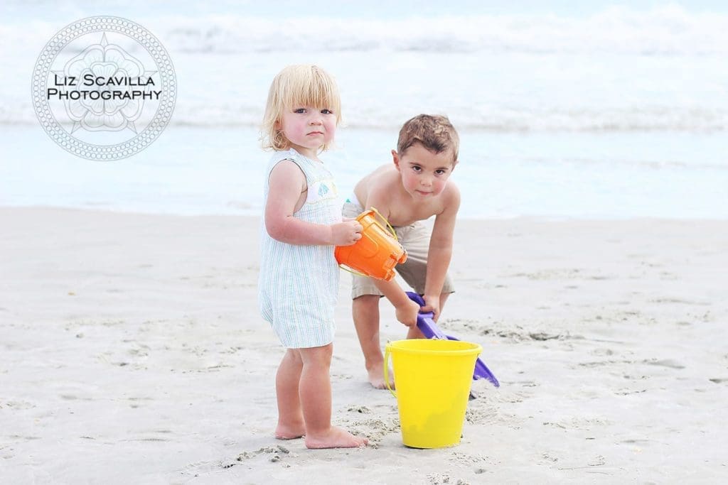 Sons Playing On Beach