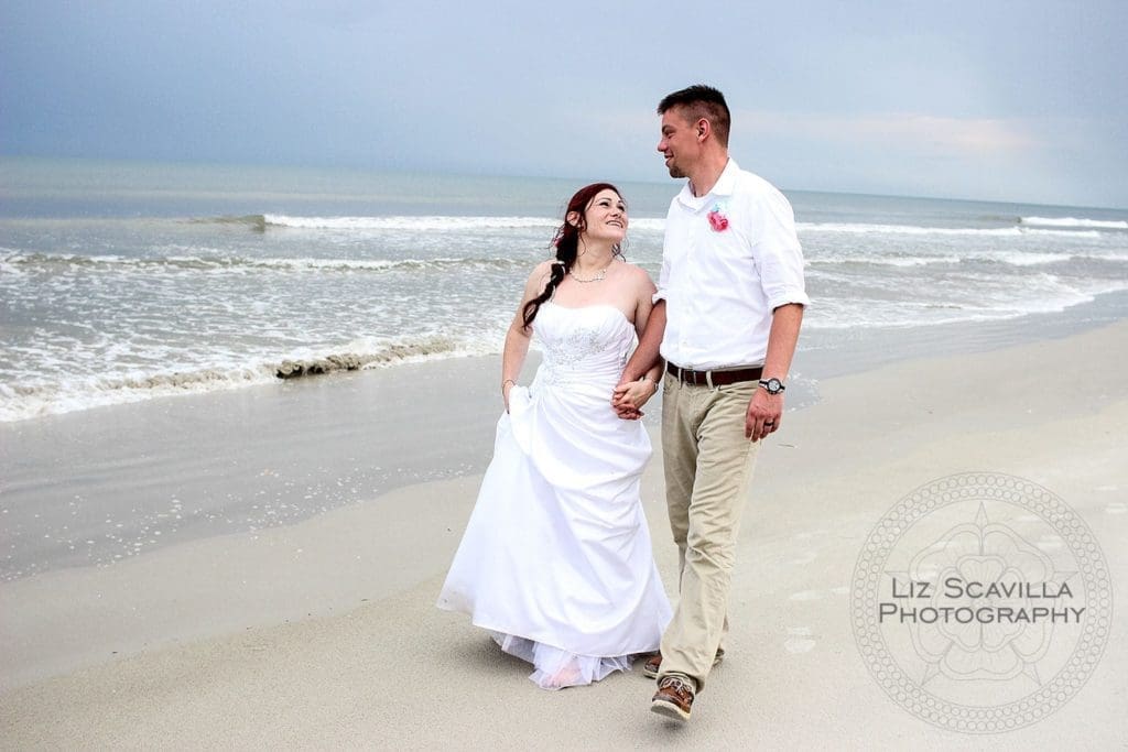 Bride and Groom Walking Along Beach