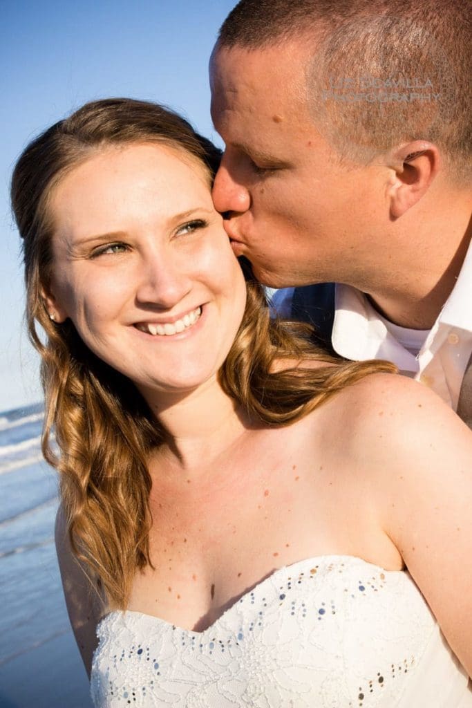 Bride smiling on beach