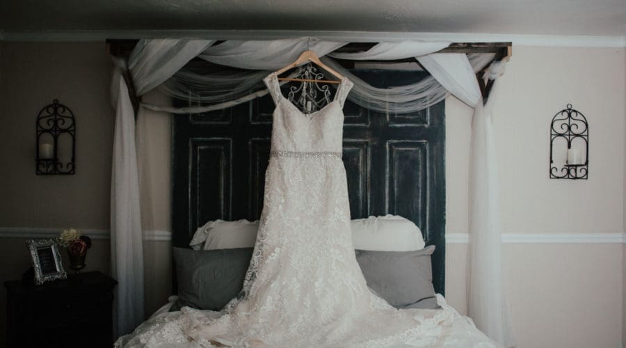 The bride's gorgeous dress hanging in the master bedroom at Bridle Oaks.