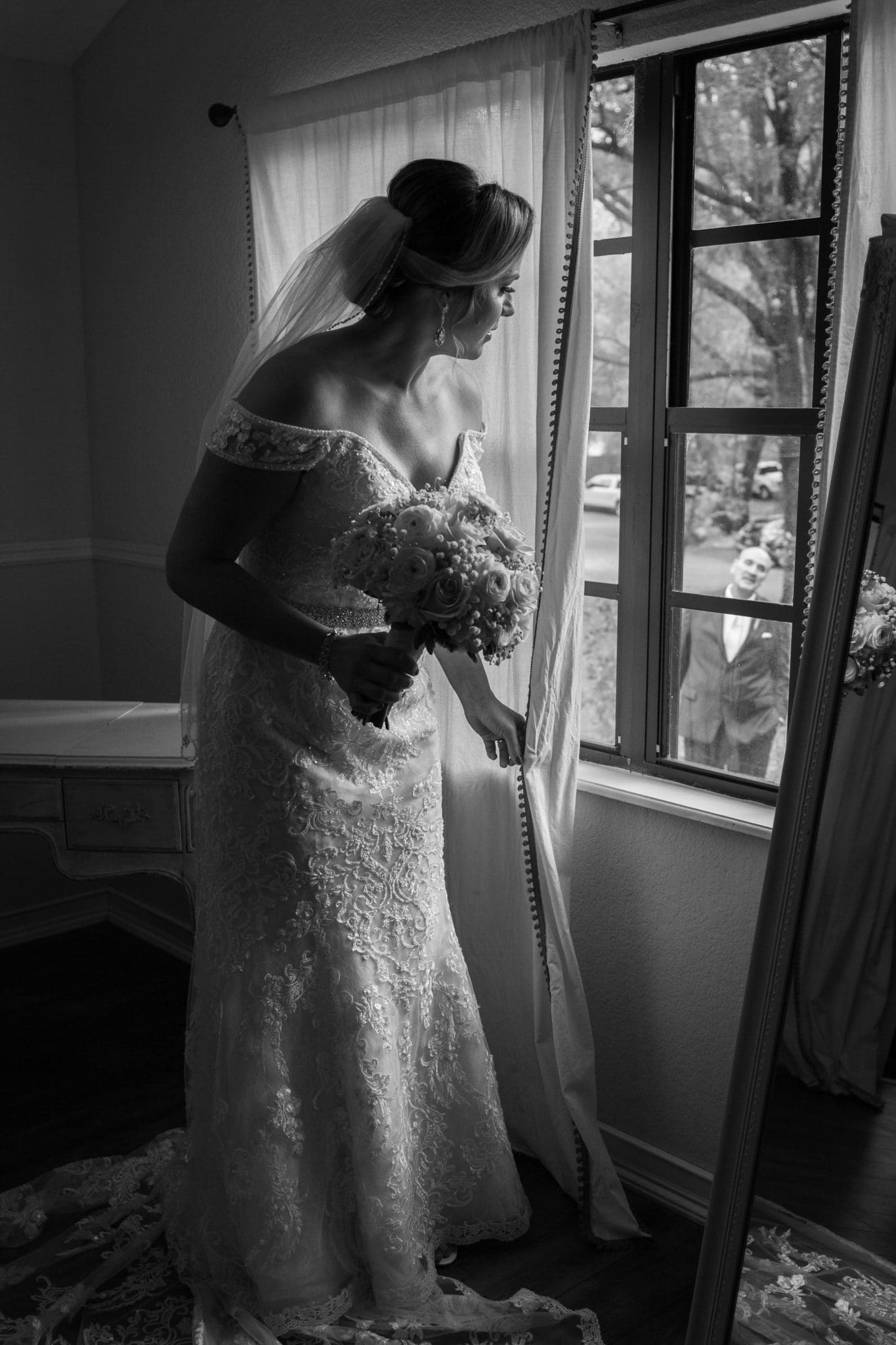 The bride seeing her father out the window.