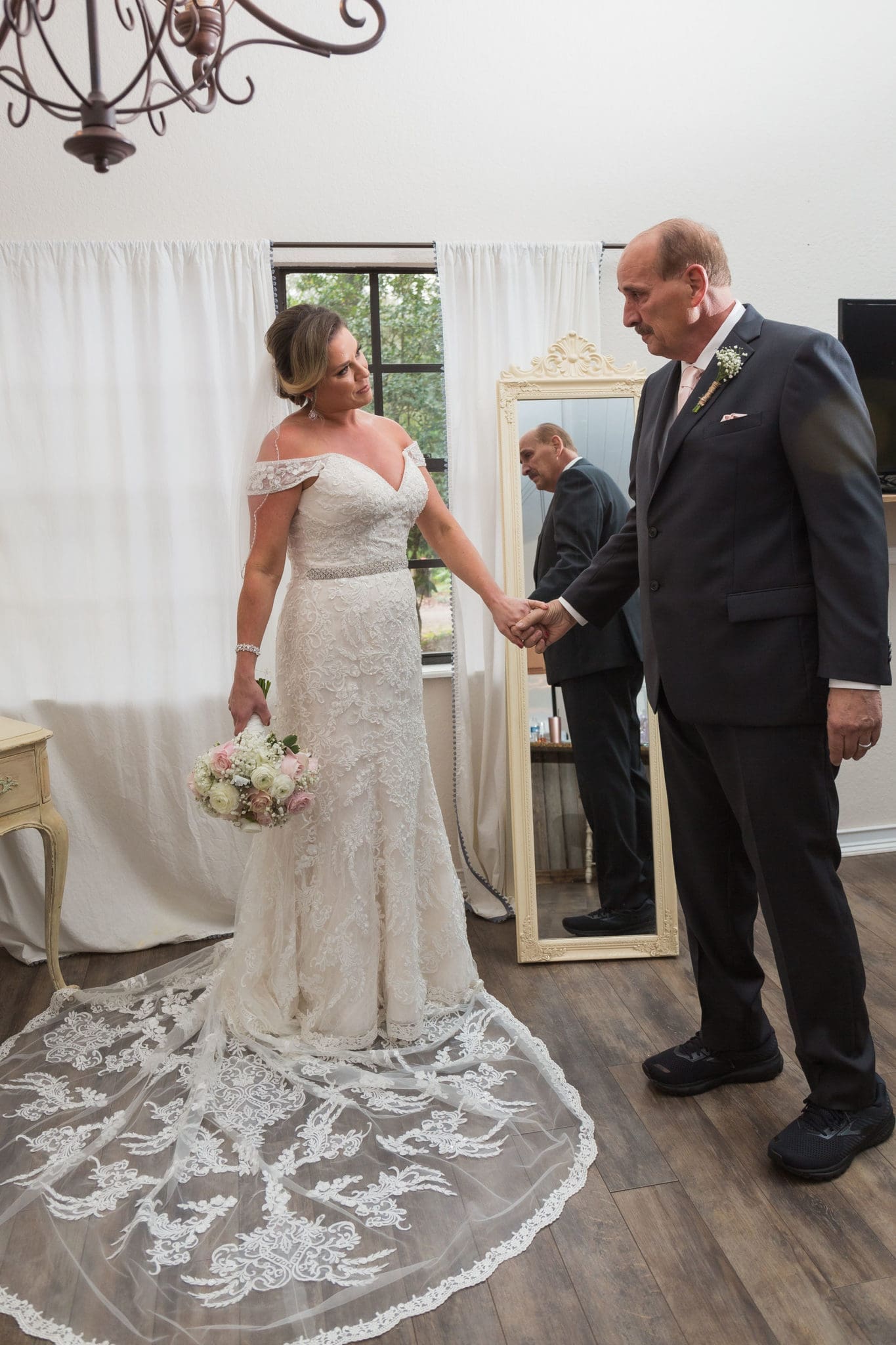 Father of the bride admiring how beautiful his daughter looks.