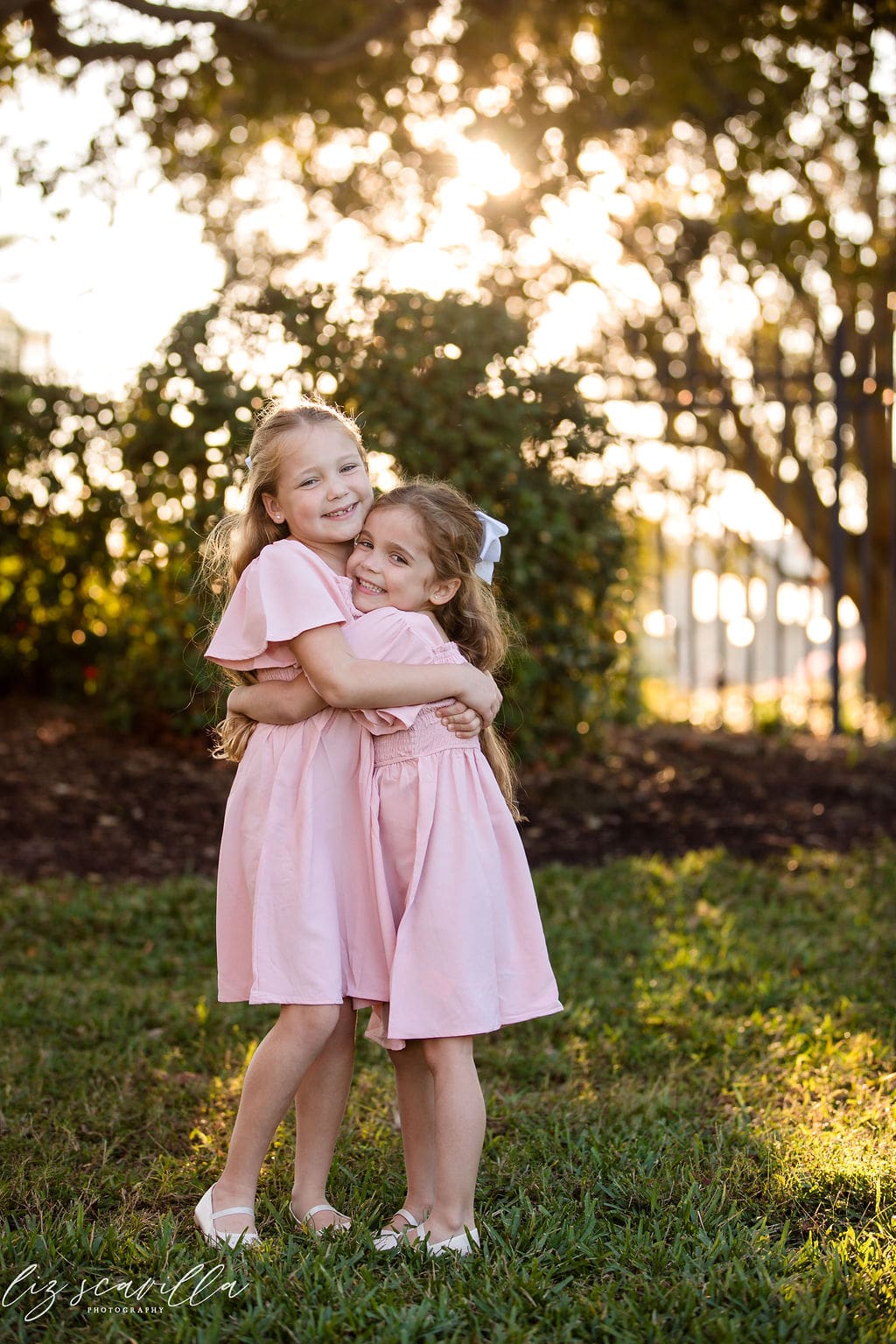 family photo outfit ideas for girls in coordinated dresses at garden session