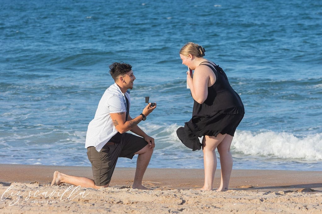 man proposing on one knee beach side angle ormond beach proposal photography